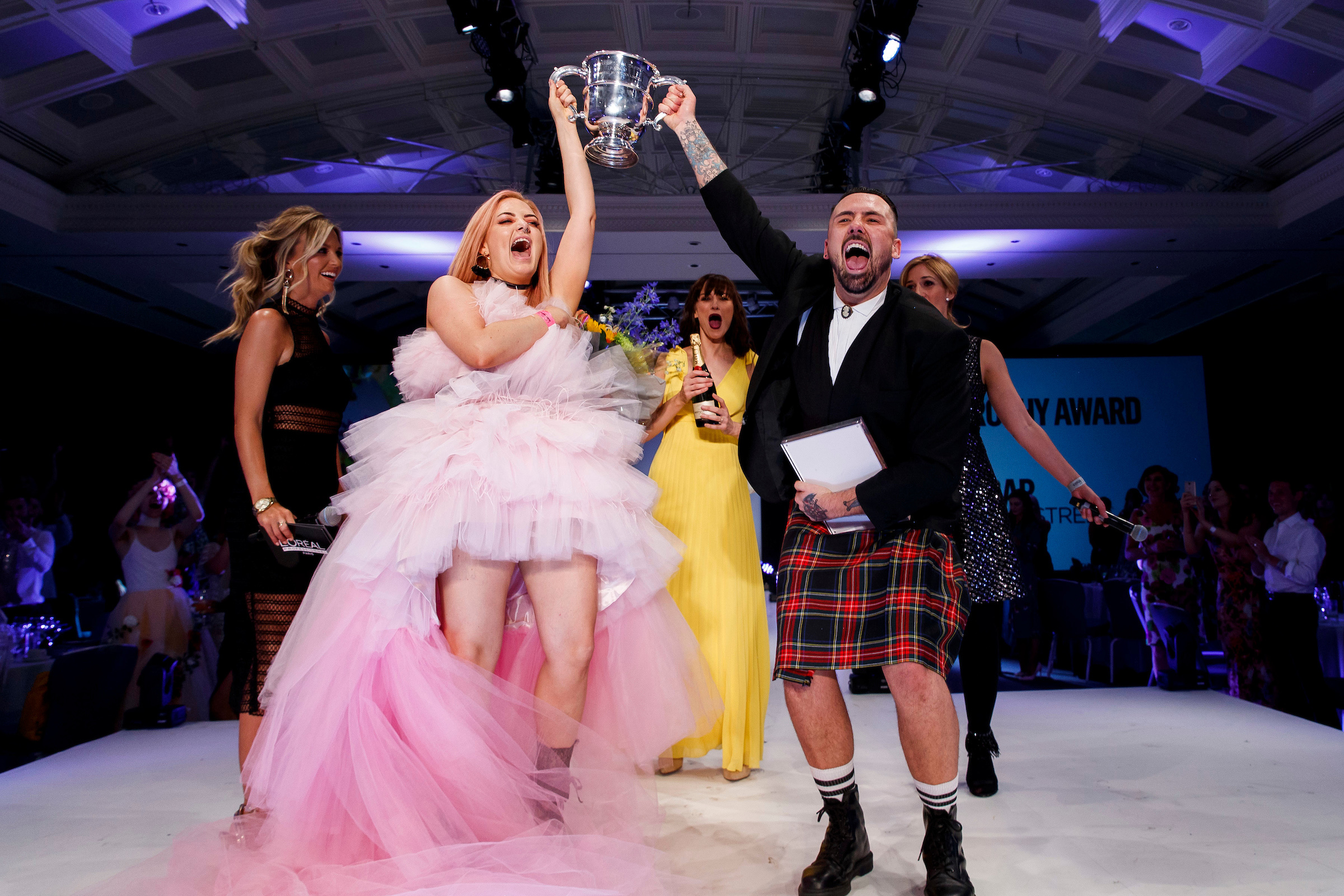 Repro Free: 02/07/2018 Pictured at the L'OrÈal Colour Trophy Grand Final 2018 at the Clayton Hotel Dublin are L'OrÈal Colour Trophy winners Laura Reid (colourist) and James Coleman (stylist) from Brown Sugar, South William Street Dublin. Ruth O'Neill MC, Dearbhla Keenan (Make up) and Beatrice Dautzenber (MD L'Oreal UK and Ireland) in the background. For futher information pleas econtcat marioleary@olearypr.ie 01-6789888 Picture Andres Poveda Photography
